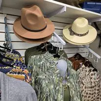 A closet with hats and jackets hanging on the wall.